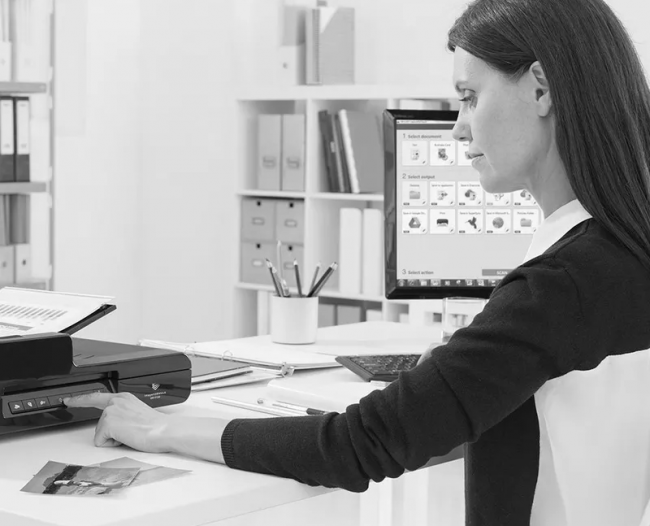 Woman with Canon DR-F120 scanner Capture solutions